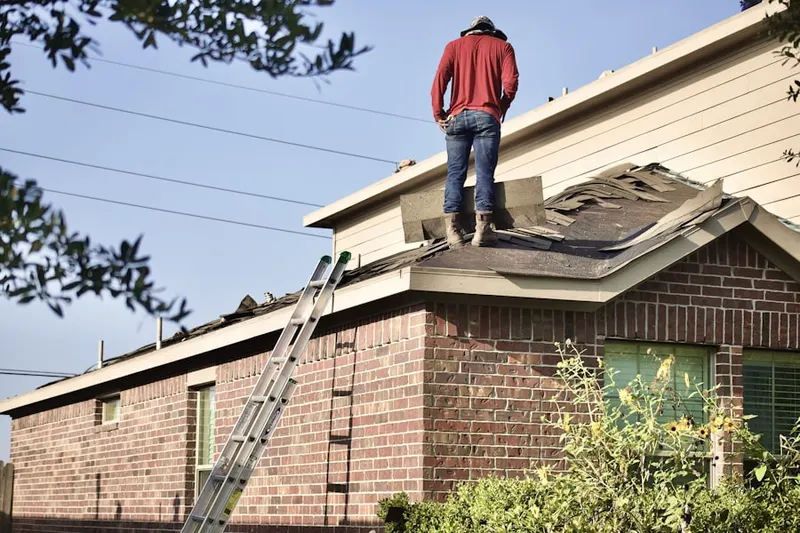 Professional roofer working on a residential roof in White Oak Estates